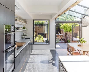 pacious conservatory extension with large windows, seamlessly connecting indoor and outdoor spaces, ideal for enhancing a small kitchen's functionality and adding value to a home.